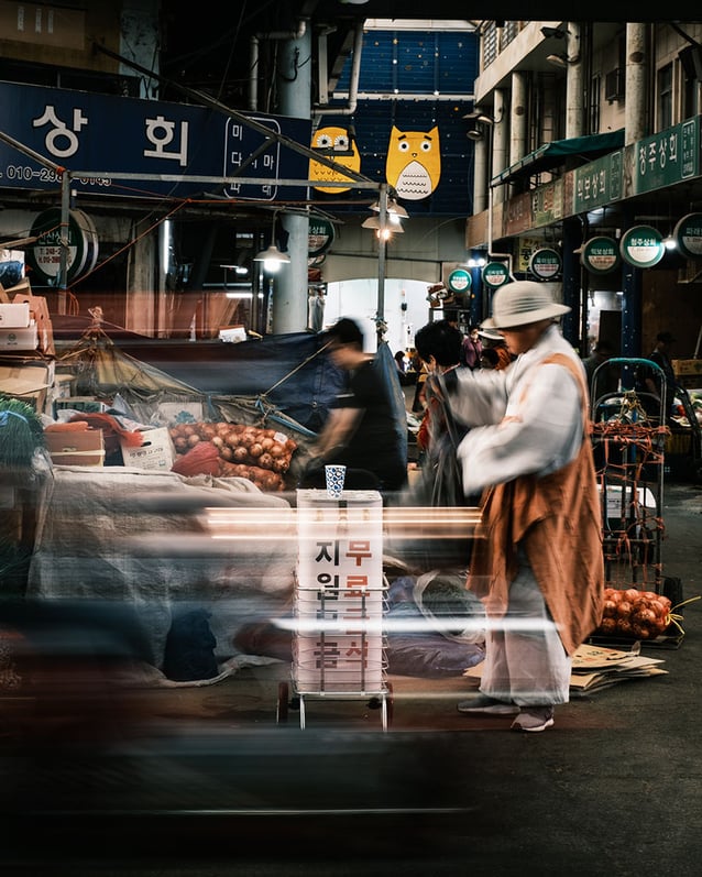 People at fish and vegetable stands in Jagalchi Fish Market.