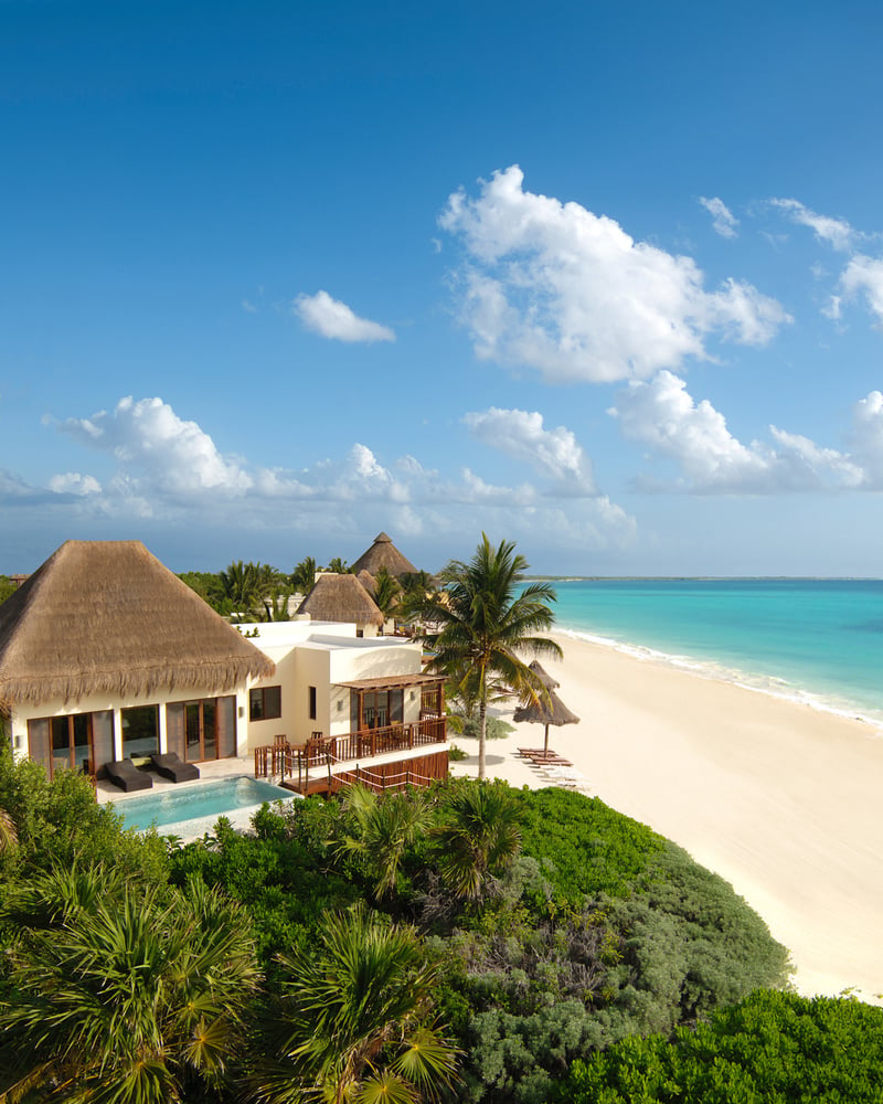 A villa at Fairmont Heritage Place Mayakoba faces the beach, surrounded by the Riviera Maya’s greenery.