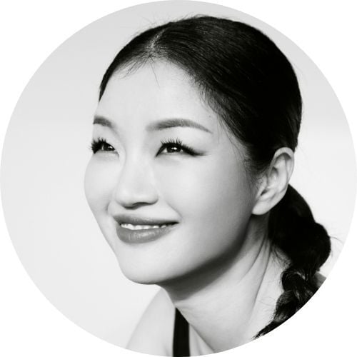 In a black-and-white photo, Soohyang Kim smiles and looks off into the distance.