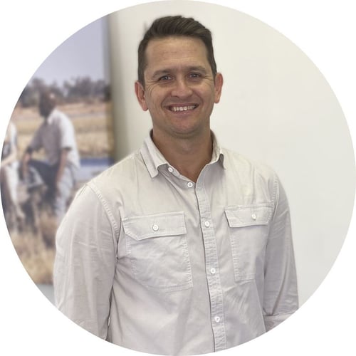 Wearing a white button-down, Vincent Shacks smiles at the camera.