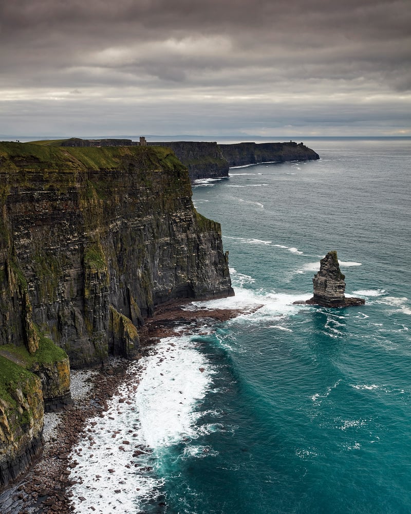 The jagged Cliffs of Moher seen on a cloudy day.
