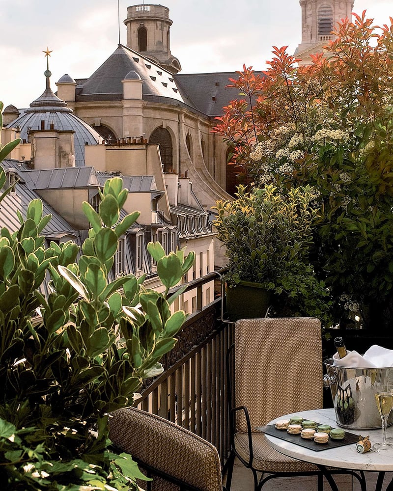 Chairs and macarons on a plant-filled terrace at Esprit Saint Germain.