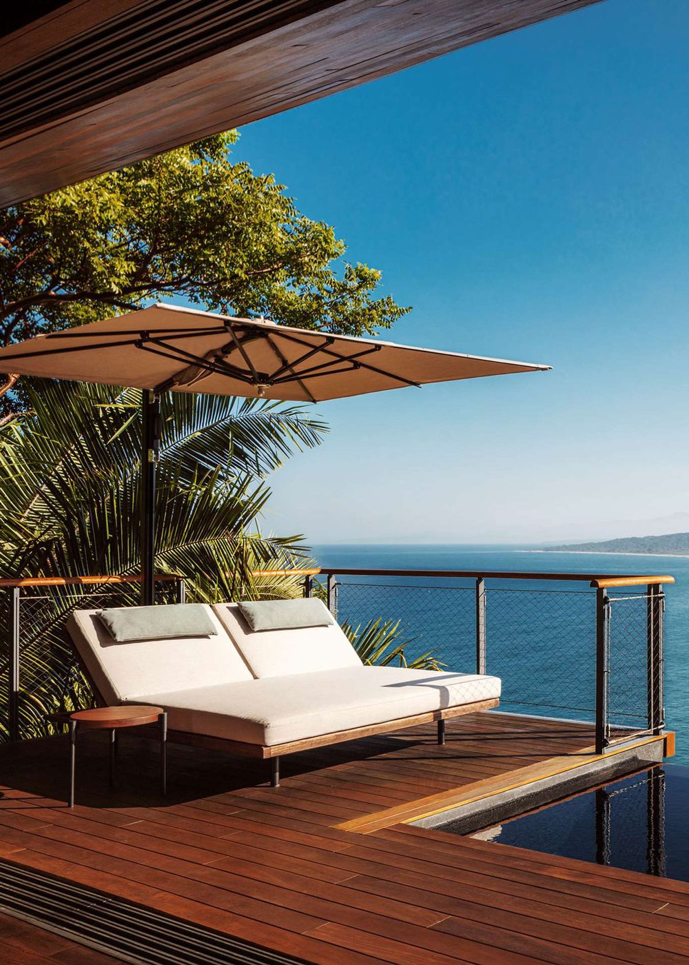 Lounge chairs on a deck at One&Only Mandarina, overlooking the sea.