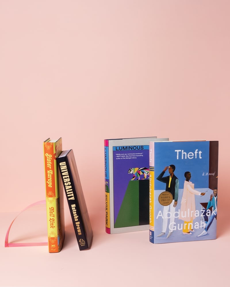 Four books are displayed against a pink background; the titles are Sister Europe, Universality, Luminous, and Theft.
