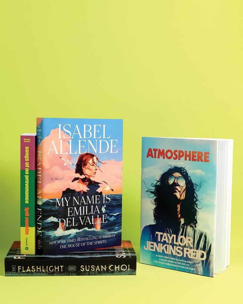 Four books – Songs of No Provenance, My Name Is Emilia del Valle, Flashlight, and Atmosphere – on a chartreuse background.