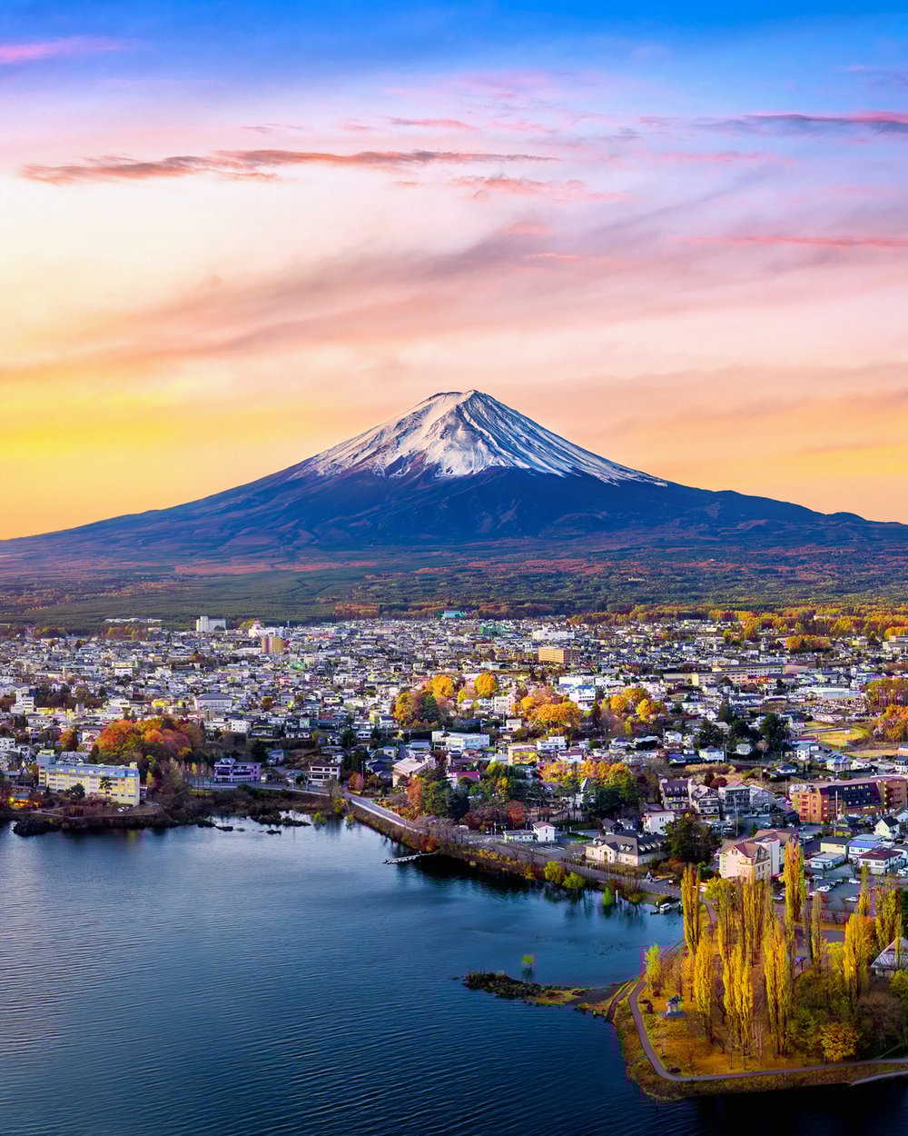 Japan’s Mount Fuji, seen from Lake Kawaguchiko, surrounded by fall colors.