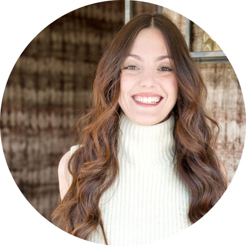 Sara Maestrelli smiles at the camera, wearing a sleeveless white turtleneck.