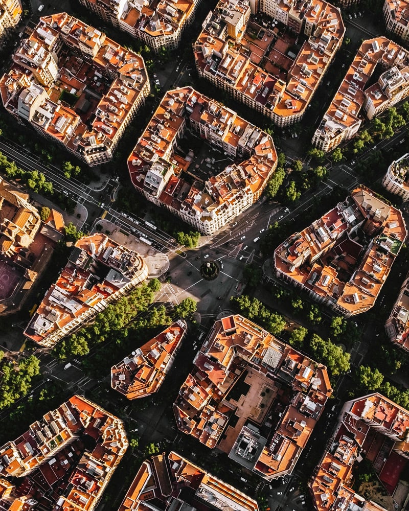 Groups of buildings in Barcelona’s Eixample neighborhood seen from overhead.